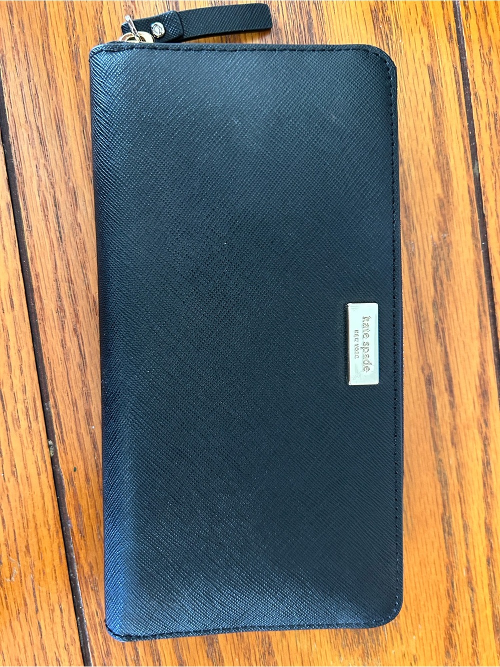 kate spade black madison zip wallet metal logo plaque.  
8x4